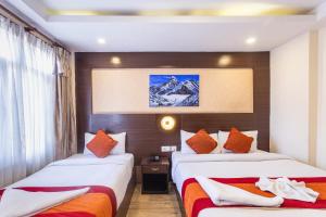 a hotel room with two beds and a window at Hotel Sapana Garden Thamel in Kathmandu