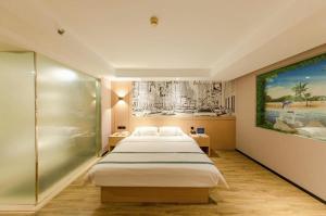 a bedroom with a bed and a painting on the wall at City Comfort Inn Beijing Capital Airport Shunyi Metro Station in Beijing +222 photos