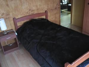 Uma cama ou camas num quarto em Hostal Aurora Coronel