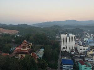 an aerial view of a city with buildings and mountains at Cathay Hotel in Betong