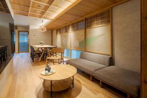a living room with a couch and a table at Suiki Machiya House in Kanazawa