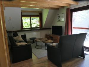 a living room with a couch and a table at De Onthaasting in Lanaken