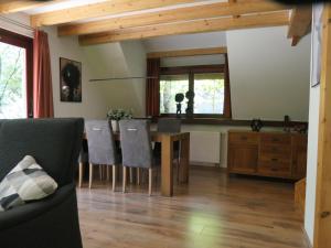 a dining room with a table and chairs at De Onthaasting in Lanaken