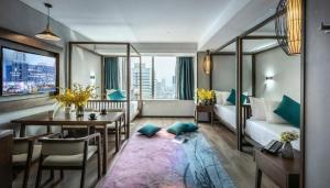 a room with a bed and a table and a couch at Grand Holiday Hotel in Shenzhen +279 photos