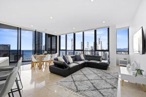 a living room with a couch and a table at Ruby - 2 Bedroom Penthouse in Surfers Paradise! in Gold Coast +27 photos
