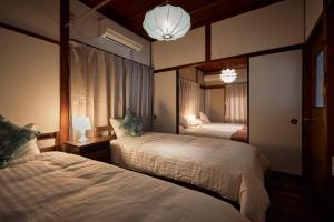 Postel nebo postele na pokoji v ubytování Momo No Yado Nagashima Nagoya