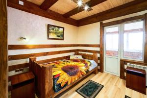 a bedroom with a bed in a room with a window at Gostiniy Dvor in Achinsk