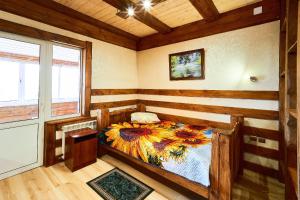 a bedroom with a bed in a room with wooden walls at Gostiniy Dvor in Achinsk