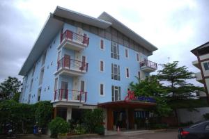 a large blue building with red balconies on it at J2 Hotel in Mae Sot