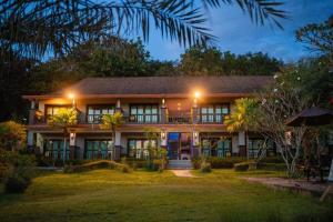 a house at night with its lights on at Poochommhok Resort in Sangkhla Buri