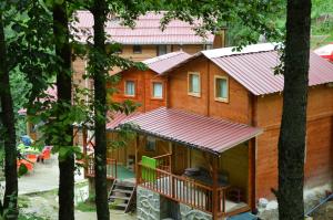 a log cabin with a red roof in the woods at Ayder Bulut Dağevi Bungalow in Ayder Yaylasi +27 photos