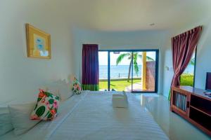 a bedroom with a bed with a view of the ocean at Villa Phra Chan Resort in Ban Pak Nam Khem Nu +174 photos