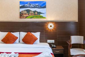 a hotel room with a bed and a painting on the wall at Hotel Sapana Garden Thamel in Kathmandu