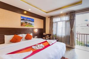 a bedroom with a large bed and a window at Hotel Sapana Garden Thamel in Kathmandu