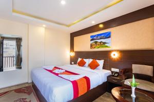 a hotel room with a bed and a desk and a table at Hotel Sapana Garden Thamel in Kathmandu