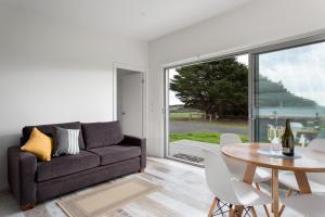 a living room with a couch and a table at Bimbadeen Phillip Island Farm Retreats in Ventnor