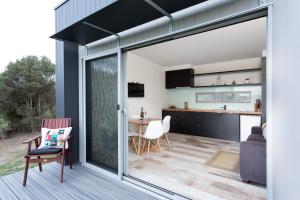 a kitchen and living room with sliding glass doors at Bimbadeen Phillip Island Farm Retreats in Ventnor