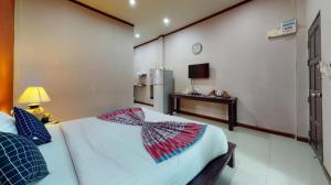 a bedroom with a bed with a bow on it at Sawasdee River Kwai Lodge in Ban Hua Hin