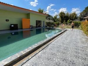 a man walking by a swimming pool next to a house at Aroma Pai Spa Hotel in Pai +134 photos