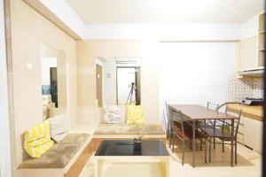 a small living room with a table and a couch at OYO 93545 Gateway Cicadas Apartment By Barbie Homestay in Bandung