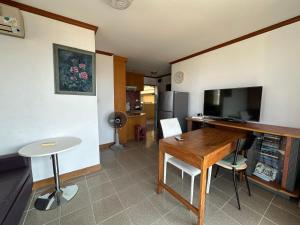 Una sala de estar con una mesa y un televisor. en The Park Land Bangna by Nudda, en Bangkok
