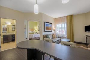 a living room with a large table in a hotel room at Candlewood Suites Jefferson City By IHG in Jefferson City