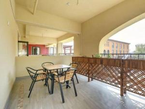 a balcony with a table and chairs on it at Qiandao Lake CBS Beer Spa Hotel in Thousand Island Lake