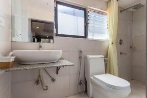 a bathroom with a sink and a toilet and a window at Hotel Sapana Garden Thamel in Kathmandu