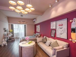 a living room with a couch and a table at Moqi Hotel Wuhan in Wuhan