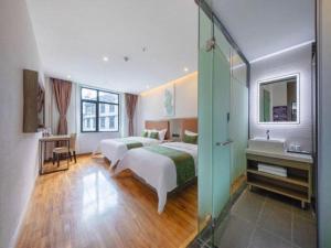 a hotel room with two beds and a bathroom at GreenTree Inn Ganzi Daochengzhou Scenic Area in Kanggar +213 photos