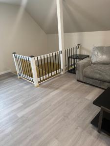 a living room with a couch and wooden floors at Downtown Golden Stairs in Buffalo