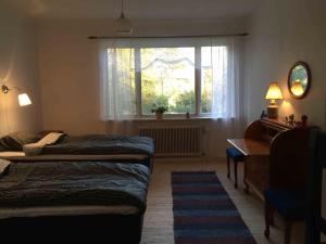 Een bed of bedden in een kamer bij Villa Insikt Pensionat & Kursgård