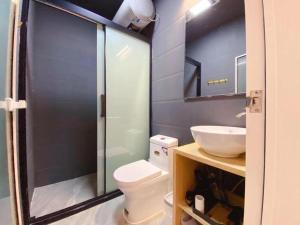 a bathroom with a shower and a toilet and a sink at Lantian Garden Hostel in Qingdao +114 photos