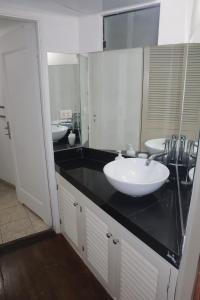 a bathroom with two sinks and a black counter at Casita de Miraflores calle Ocharan a 5 minutos de Larcomar in Lima +37 photos