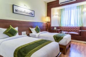 Cama o camas de una habitación en Treebo Premium Grand Emerald