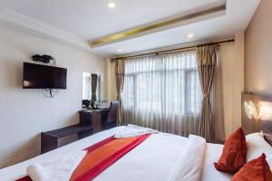 a hotel room with a bed and a television at Hotel Sapana Garden Thamel in Kathmandu