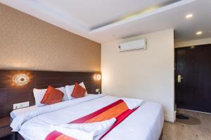 a bedroom with a large white bed with red pillows at Hotel Sapana Garden Thamel in Kathmandu