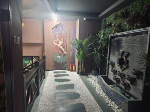 a walkway with rocks and plants in a room at Harmony Resort Hotel Zhuhai in Zhuhai