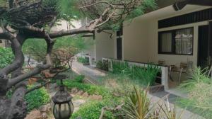 a house with a street light next to a tree at d'Arcici Hotel Plumpang in Jakarta