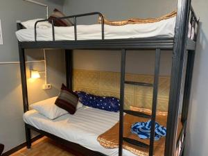 a couple of bunk beds in a room at Wanghin Bungalow in Surat Thani
