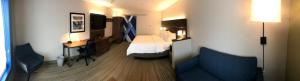 a small hotel room with a bed and a couch at Holiday Inn Express and Suites Hannibal-Medical Center By IHG in Hannibal +74 photos
