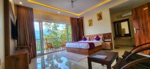 a bedroom with a bed and a balcony at Evaara Resorts in Anachal