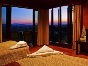 a bedroom with two beds and a large window at Thaton Hill Resort in Mae Ai +149 photos