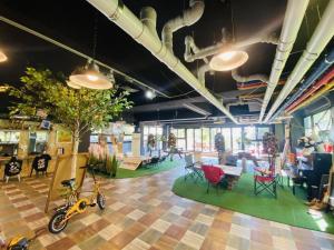 a room with chairs and a bike on the floor at Momento Hotel in Seogwipo