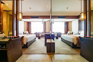 a hotel room with four beds and a table at Yitel Collection Chengdu Kuanzhai Alley Chutian Junlin in Chengdu