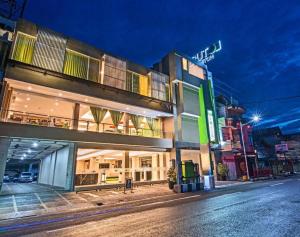 a building on the side of a street at night at Lotus Hotel Subang in Bandung