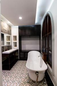 a bathroom with a white tub and a sink at Mylaohome Guesthouse & Spa in Luang Prabang +159 photos