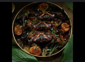 a pan of food with meat and vegetables in it at Paradise Farm Alibaug in Kashid