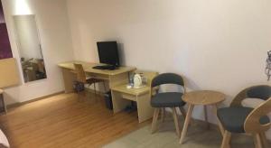 a room with a desk with a computer and chairs at 7 Days Inn Shantou High-Speed Railway Station Zhujiang Road Food Street in Ma Yu