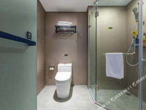 a bathroom with a toilet and a glass shower at 7 Days Inn Nanchang Bayi Square Zhongshan Road Wanshou Palace in Nanchang +142 photos
